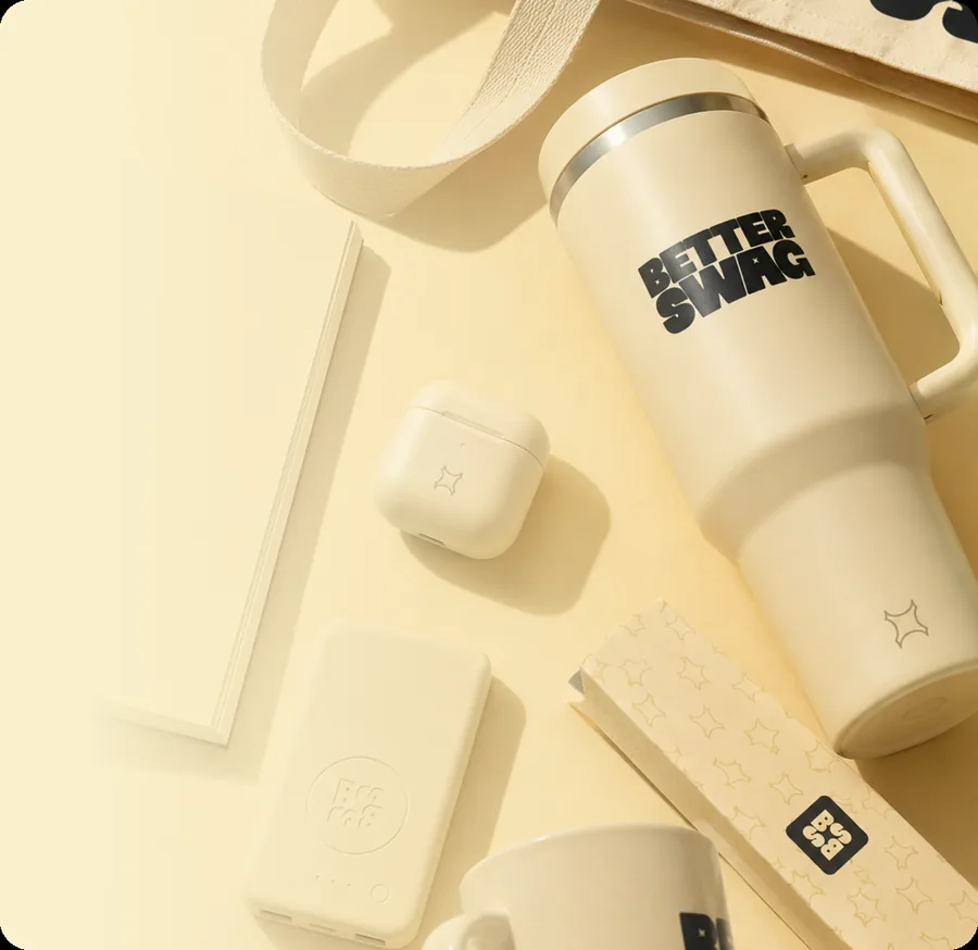 Cream Better Swag tumbler, mug and notebook laid out from the Catalog