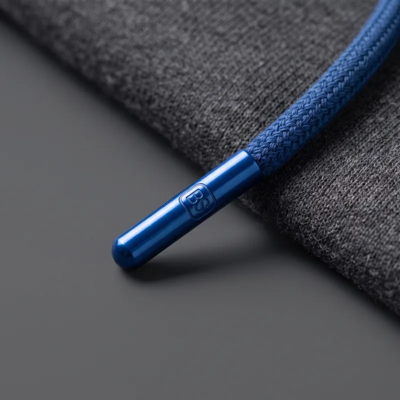 Custom metal aglet on a blue drawcord