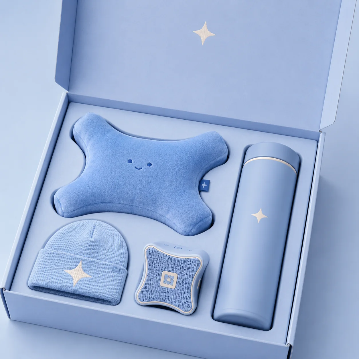 Blue gift box with plush, beanie, and bottle